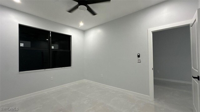 spare room with a ceiling fan, recessed lighting, and baseboards