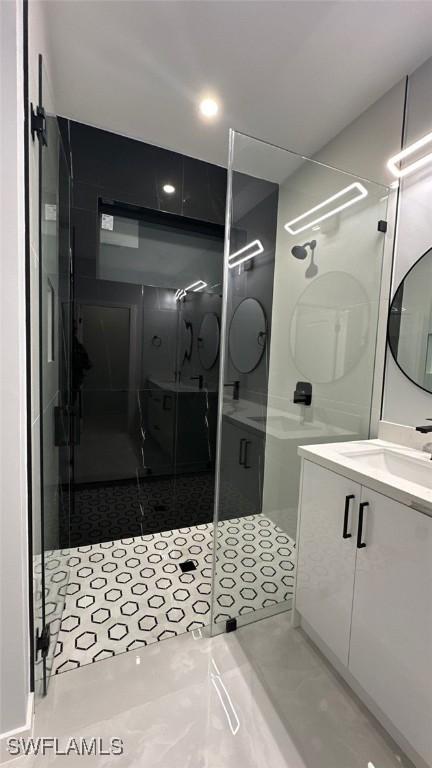 bathroom featuring a stall shower and vanity