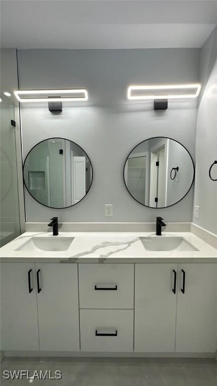 bathroom featuring a sink and double vanity