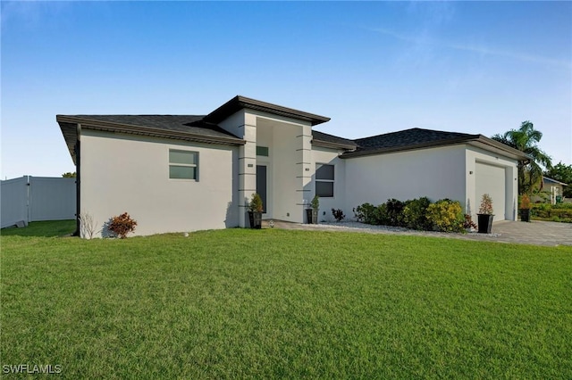 view of front of home with a front yard and a garage