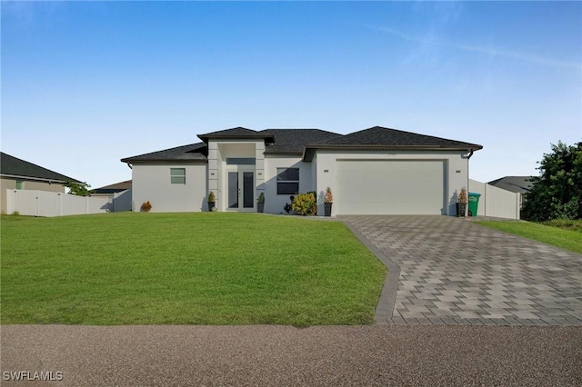 view of front of home featuring a garage and a front lawn