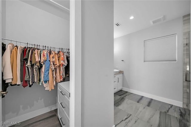 interior space featuring vanity and walk in shower