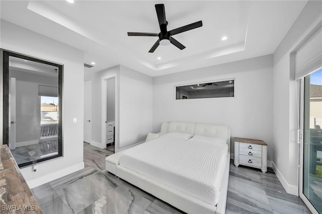 bedroom featuring a tray ceiling and ceiling fan