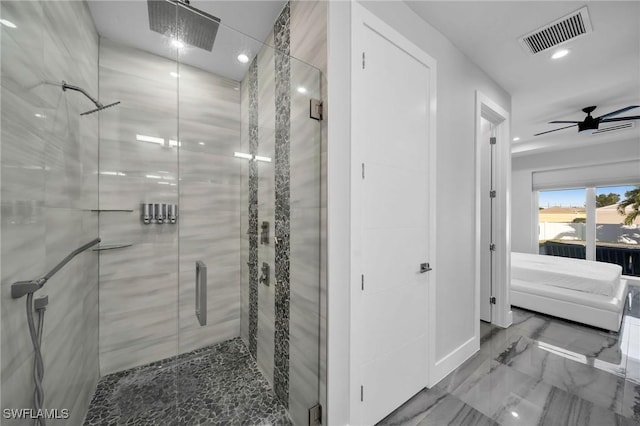 bathroom featuring ceiling fan and a shower with shower door