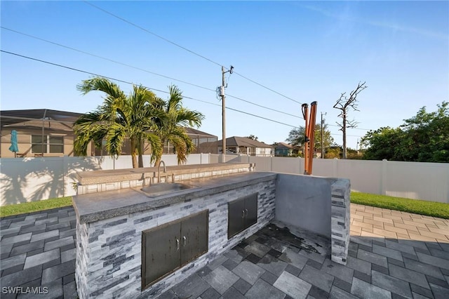 view of patio with sink and an outdoor kitchen