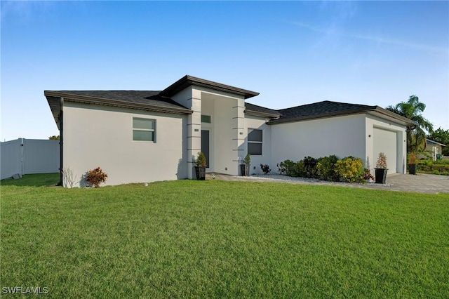 view of front of property featuring a front lawn and a garage