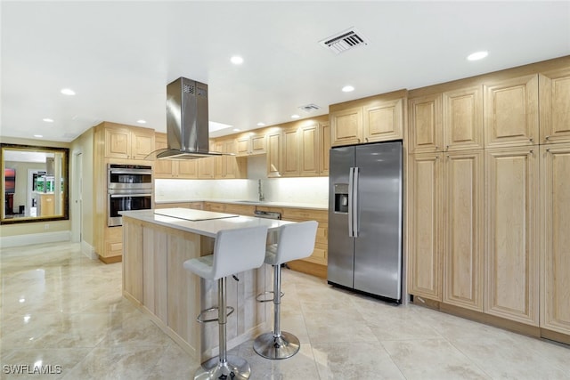 kitchen featuring a breakfast bar, a center island, island range hood, stainless steel appliances, and light brown cabinetry