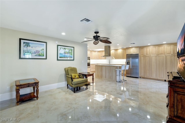 sitting room featuring ceiling fan