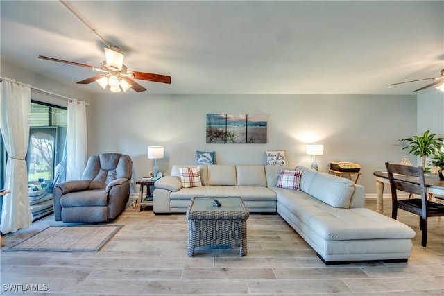 living room with light wood-type flooring and a ceiling fan