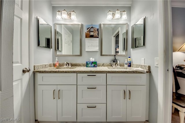 full bathroom with double vanity and a sink