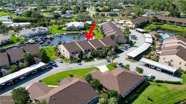 bird's eye view featuring a water view and a residential view