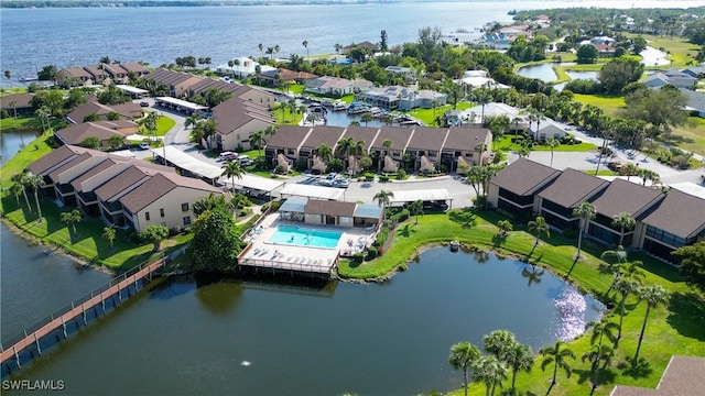 birds eye view of property with a water view and a residential view