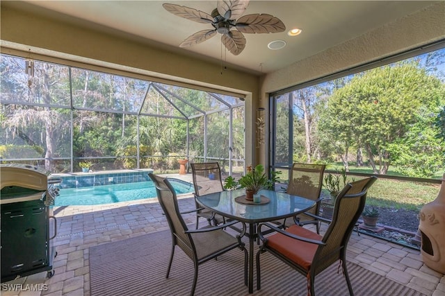 sunroom / solarium featuring ceiling fan