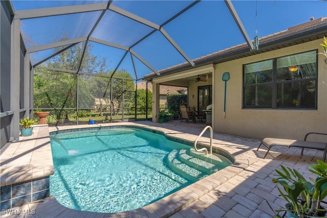 pool with a ceiling fan, a lanai, and a patio area