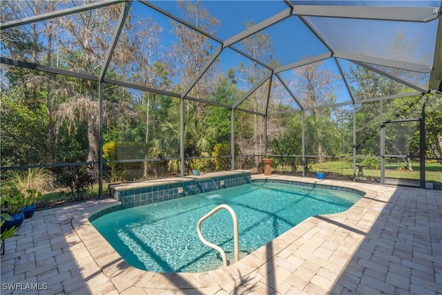 outdoor pool featuring a patio area and glass enclosure