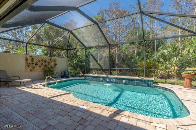 outdoor pool with a lanai and a patio