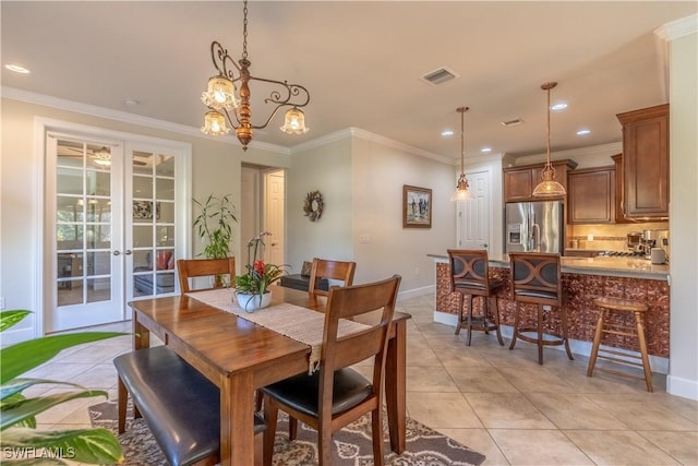 dining space featuring light tile patterned floors, visible vents, crown molding, and french doors