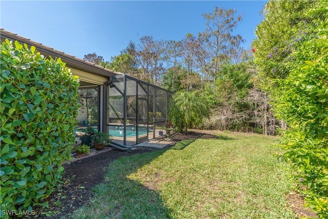 view of yard with glass enclosure and an outdoor pool