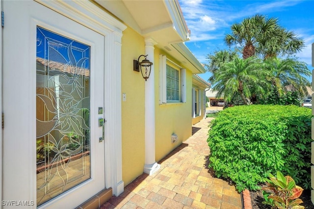 entrance to property featuring stucco siding