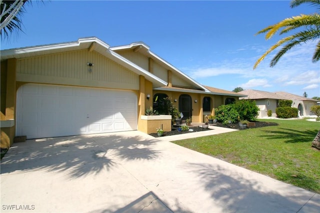 ranch-style house with concrete driveway, stucco siding, an attached garage, and a front yard