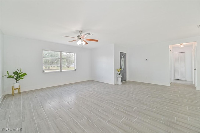 empty room featuring ceiling fan and light hardwood / wood-style flooring