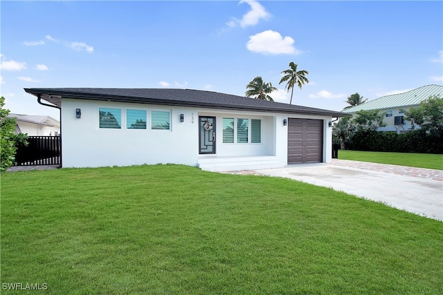 view of front facade with a garage and a front yard