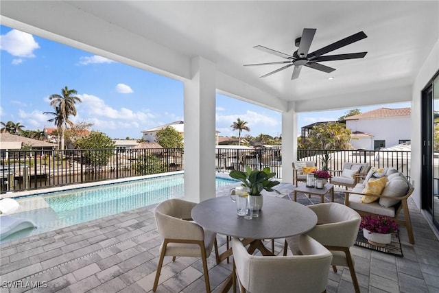 exterior space with an outdoor living space, a fenced in pool, and ceiling fan