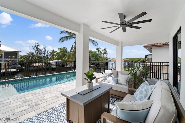 exterior space featuring a water view, an outdoor hangout area, and ceiling fan