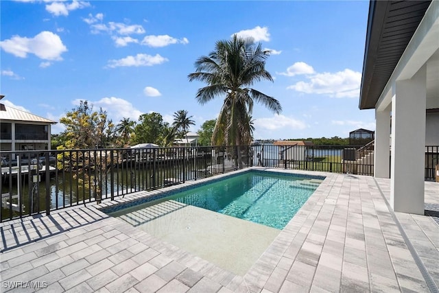 view of swimming pool with a water view and a patio