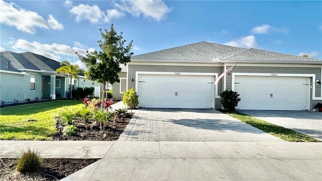 single story home with a front lawn and a garage