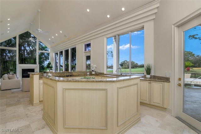 kitchen featuring a center island, open floor plan, and light stone countertops