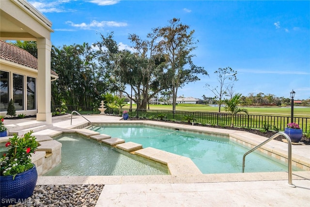 view of pool featuring a patio, a fenced backyard, and a pool with connected hot tub