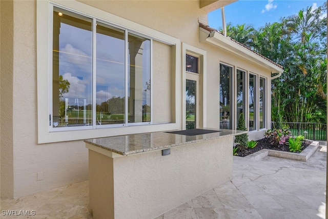 view of patio / terrace featuring fence