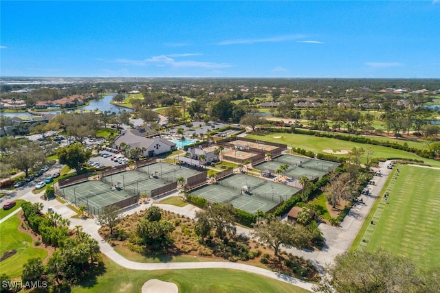 drone / aerial view with view of golf course and a water view