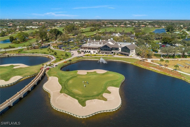 drone / aerial view with golf course view and a water view