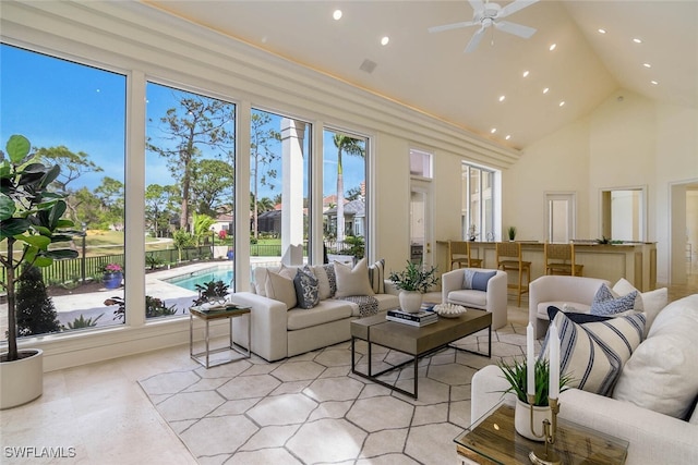 sunroom with lofted ceiling and ceiling fan