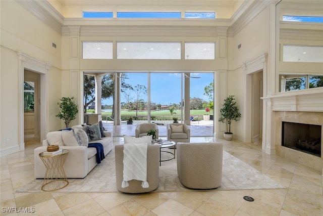 living room featuring a tiled fireplace and baseboards