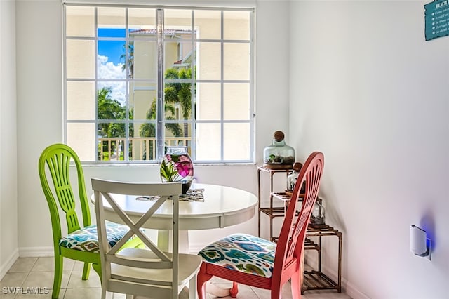 dining area featuring baseboards and light tile patterned flooring