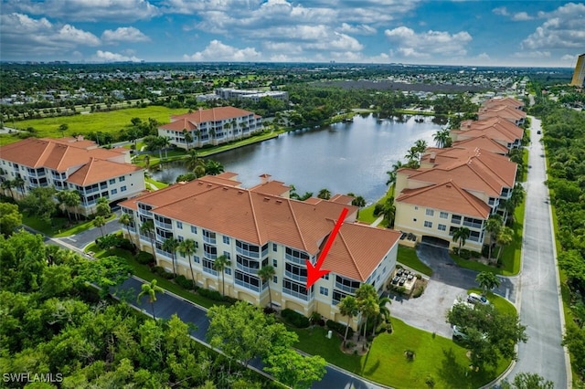 bird's eye view featuring a water view and a residential view