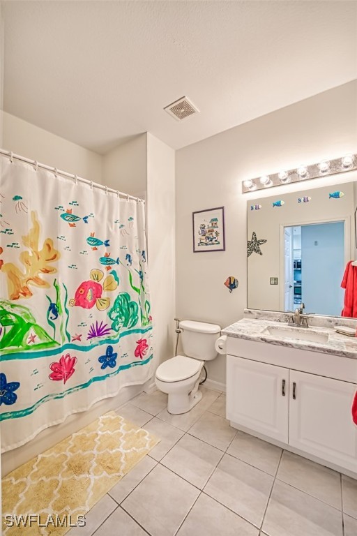 full bath with tile patterned flooring, toilet, vanity, visible vents, and shower / bath combo