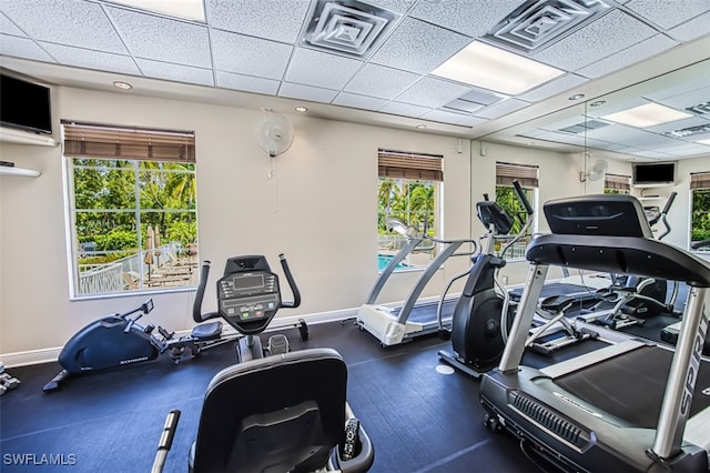 gym featuring baseboards, visible vents, and a drop ceiling