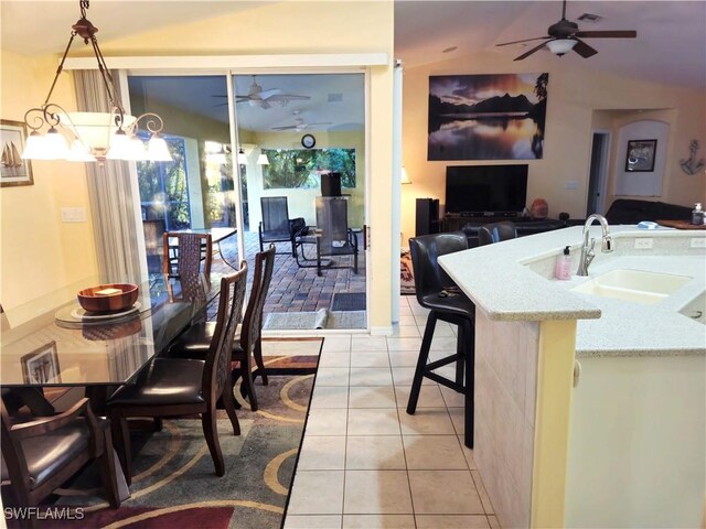 142 SE 30th Ter, Cape Coral, FL 33904 - dining space featuring a ceiling fan, light tile patterned flooring, and vaulted ceiling