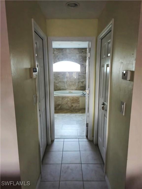 142 SE 30th Ter, Cape Coral, FL 33904 - hallway featuring light tile patterned floors