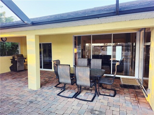142 SE 30th Ter, Cape Coral, FL 33904 - view of patio / terrace with grilling area, outdoor dining space, and glass enclosure