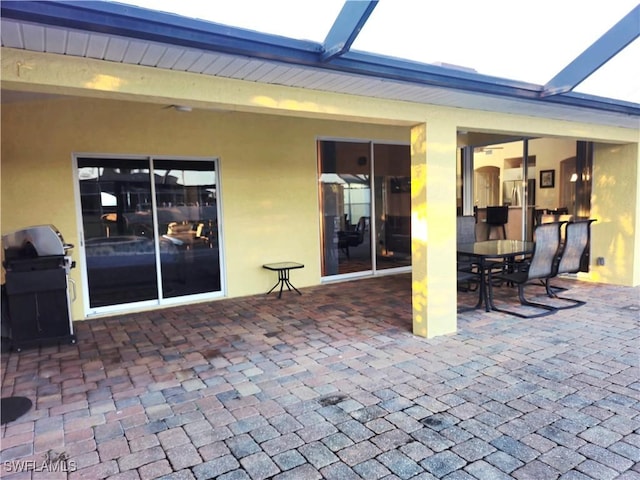 142 SE 30th Ter, Cape Coral, FL 33904 - view of patio / terrace featuring a grill, glass enclosure, and outdoor dining space