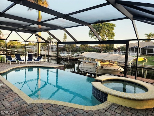 142 SE 30th Ter, Cape Coral, FL 33904 - view of swimming pool with a dock, a pool with connected hot tub, glass enclosure, a water view, and a patio