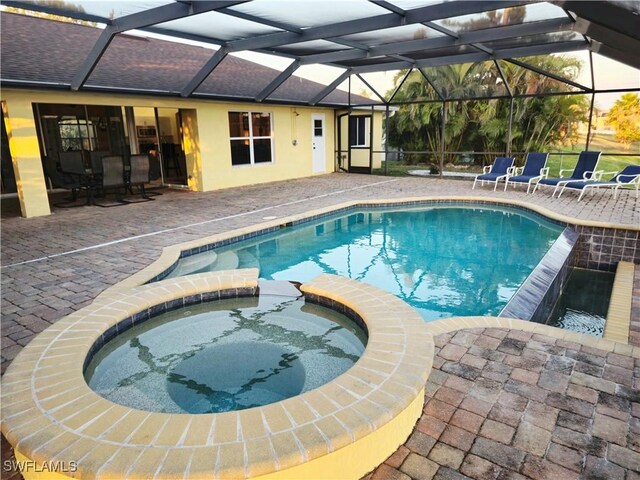 142 SE 30th Ter, Cape Coral, FL 33904 - view of pool with a pool with connected hot tub, a patio area, and a lanai