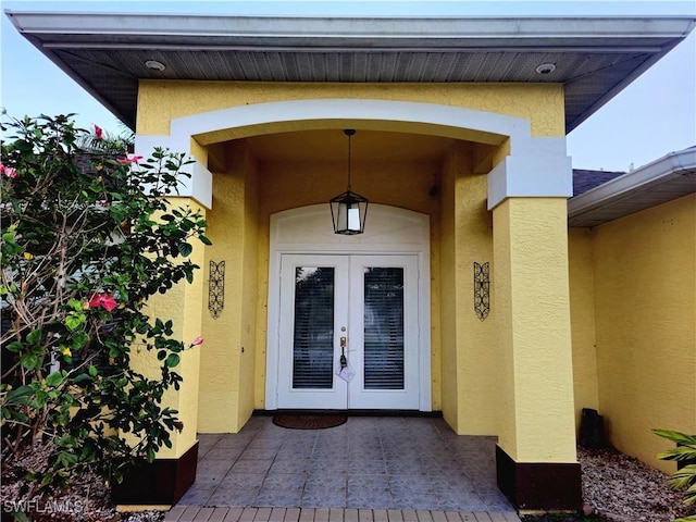 142 SE 30th Ter, Cape Coral, FL 33904 - doorway to property with french doors and stucco siding