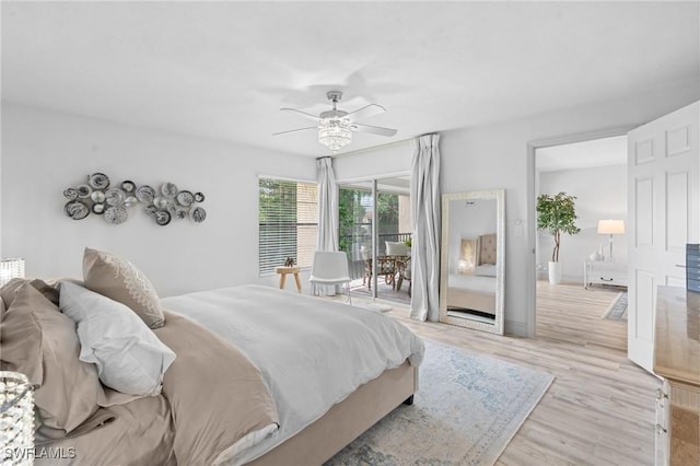 bedroom with ceiling fan, access to outside, and wood finished floors