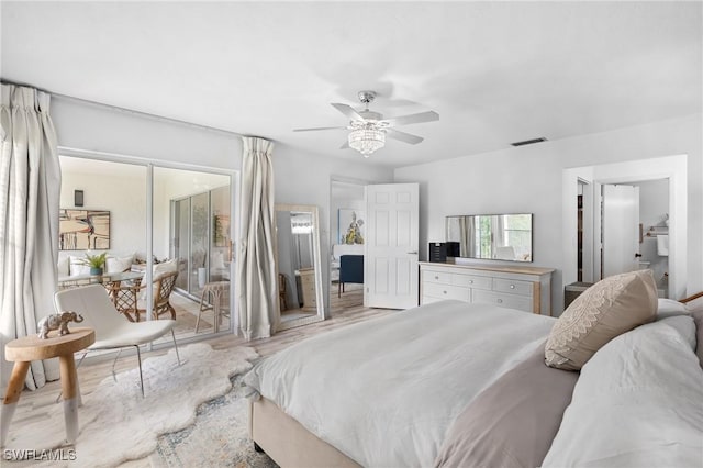 bedroom with light wood-style flooring, visible vents, and ceiling fan